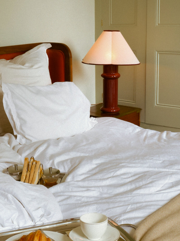 heath table lamp next to living room sofa on a side table