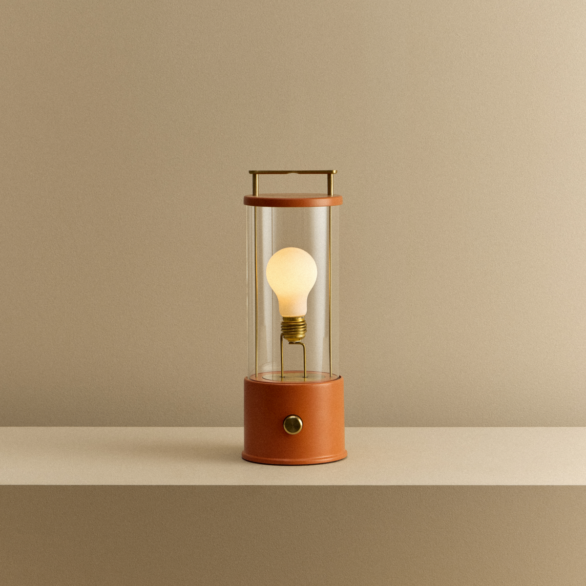 The Muse 2.0 Portable Lamp in Claycourt Orange, lit