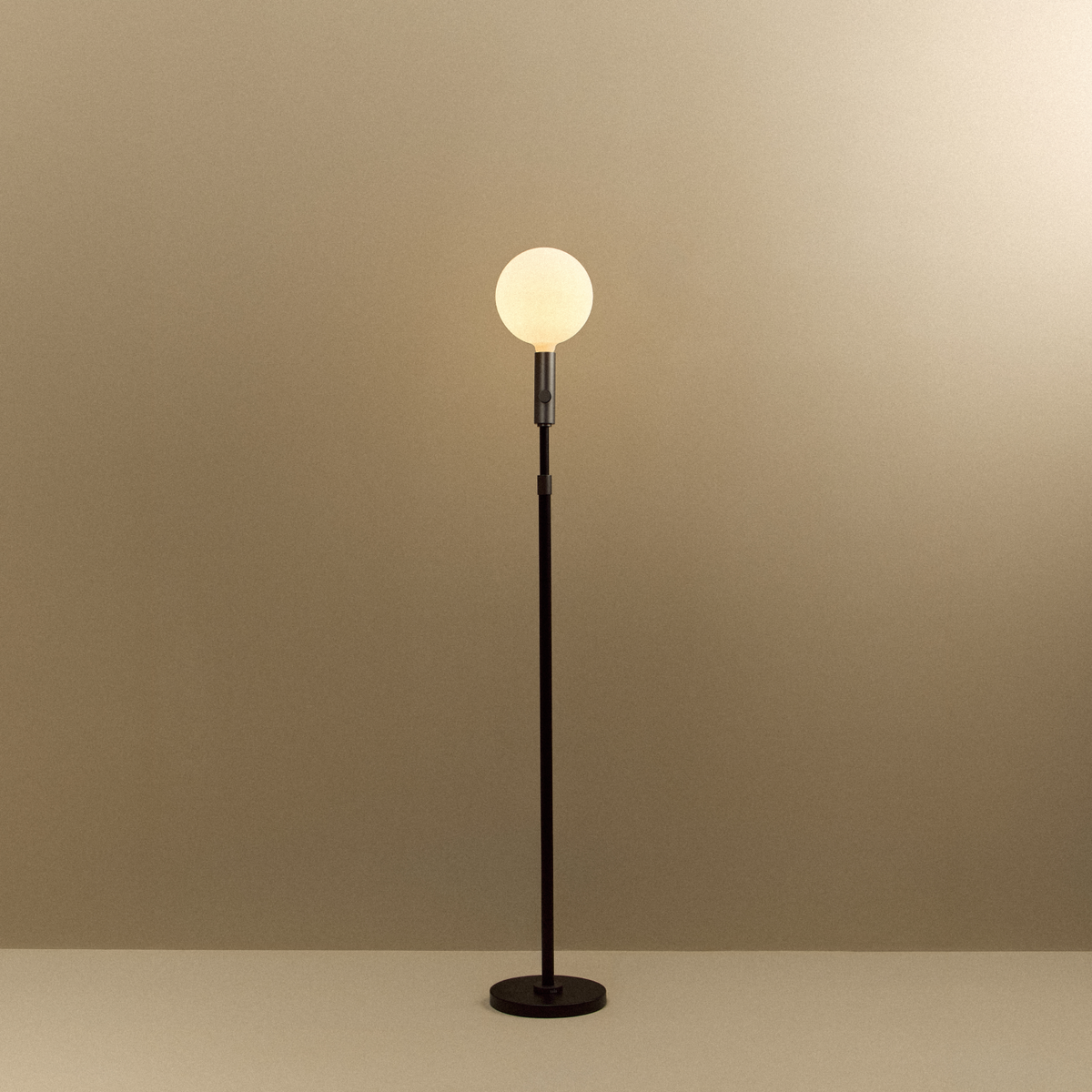 Poise Adjustable Floor Lamp in Graphite, switched on