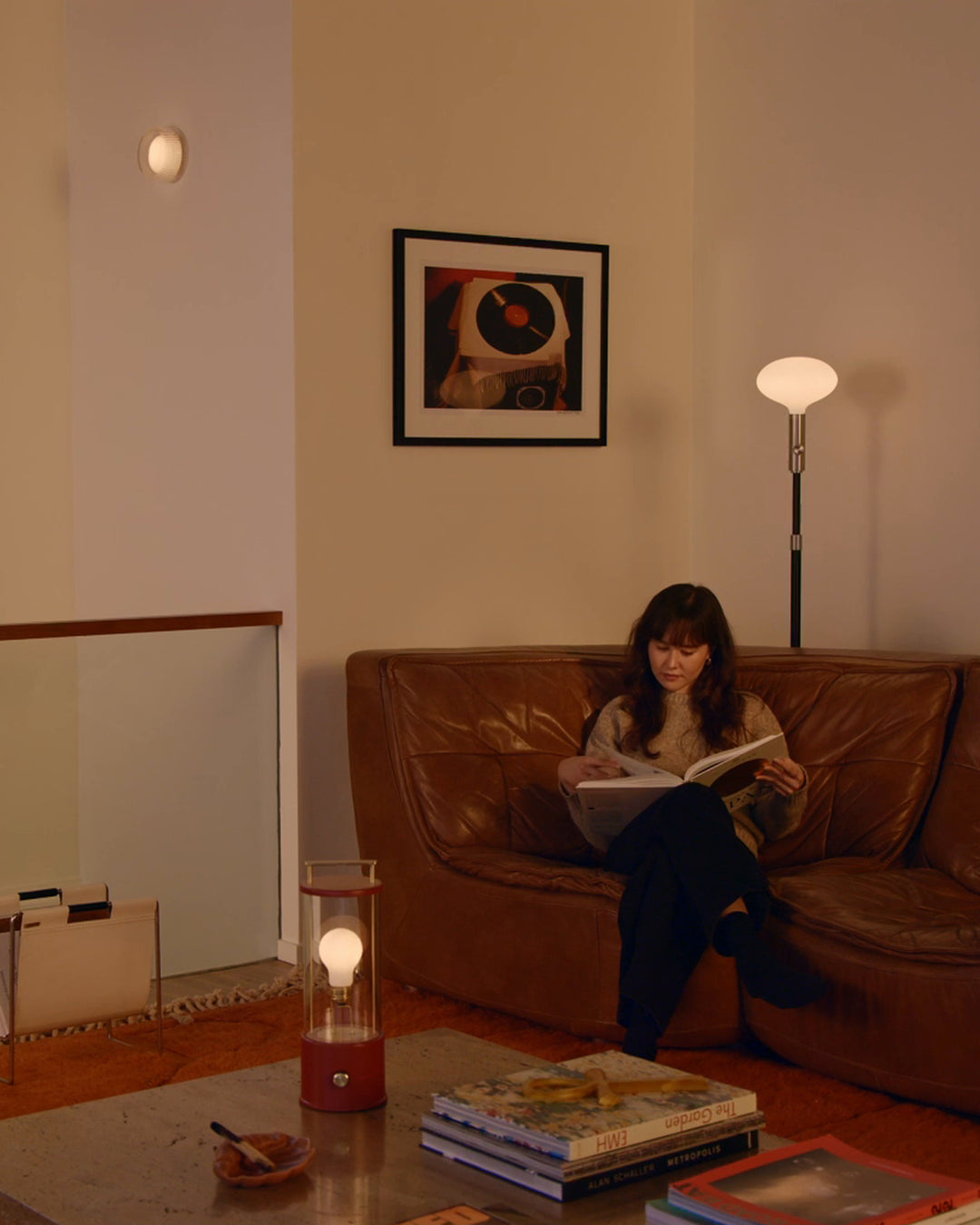 poise floor lamp, firth wall light, and the muse 2.0 portable lamp in a living room