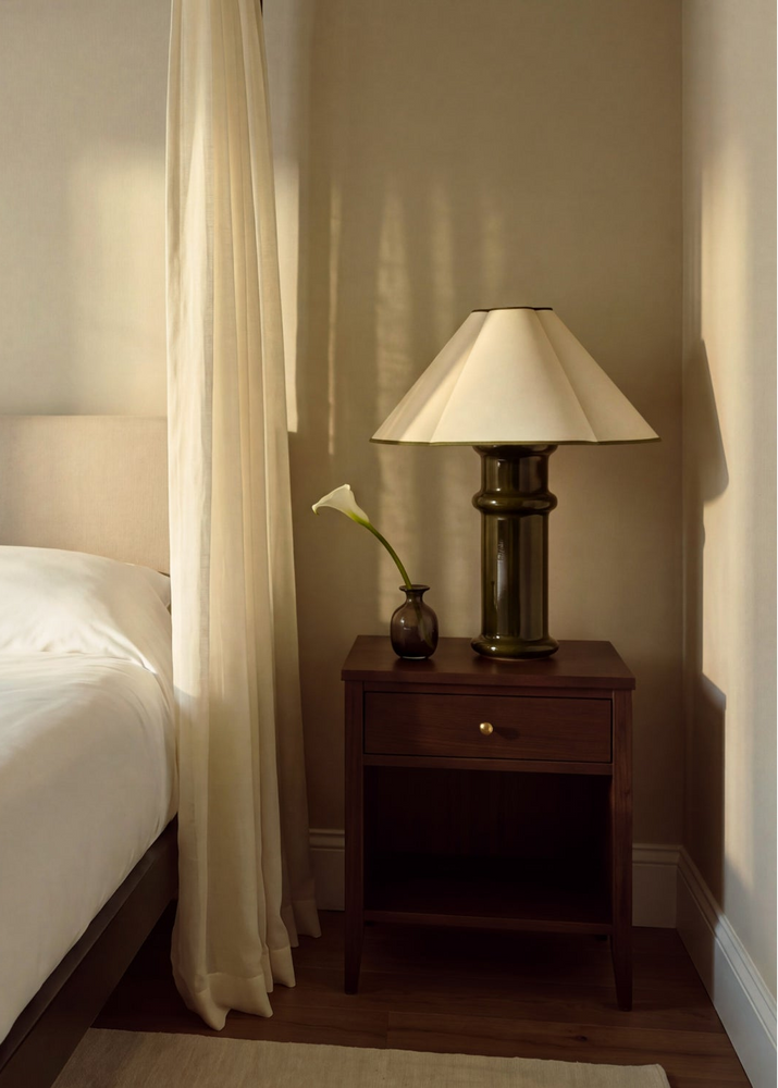 heath table lamp next to living room sofa on a side table
